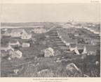 Thumbnail photo of St. Paul Village, looking toward Zoltoi Sands from 1896, a historic picture of a collection of light colored buildings.